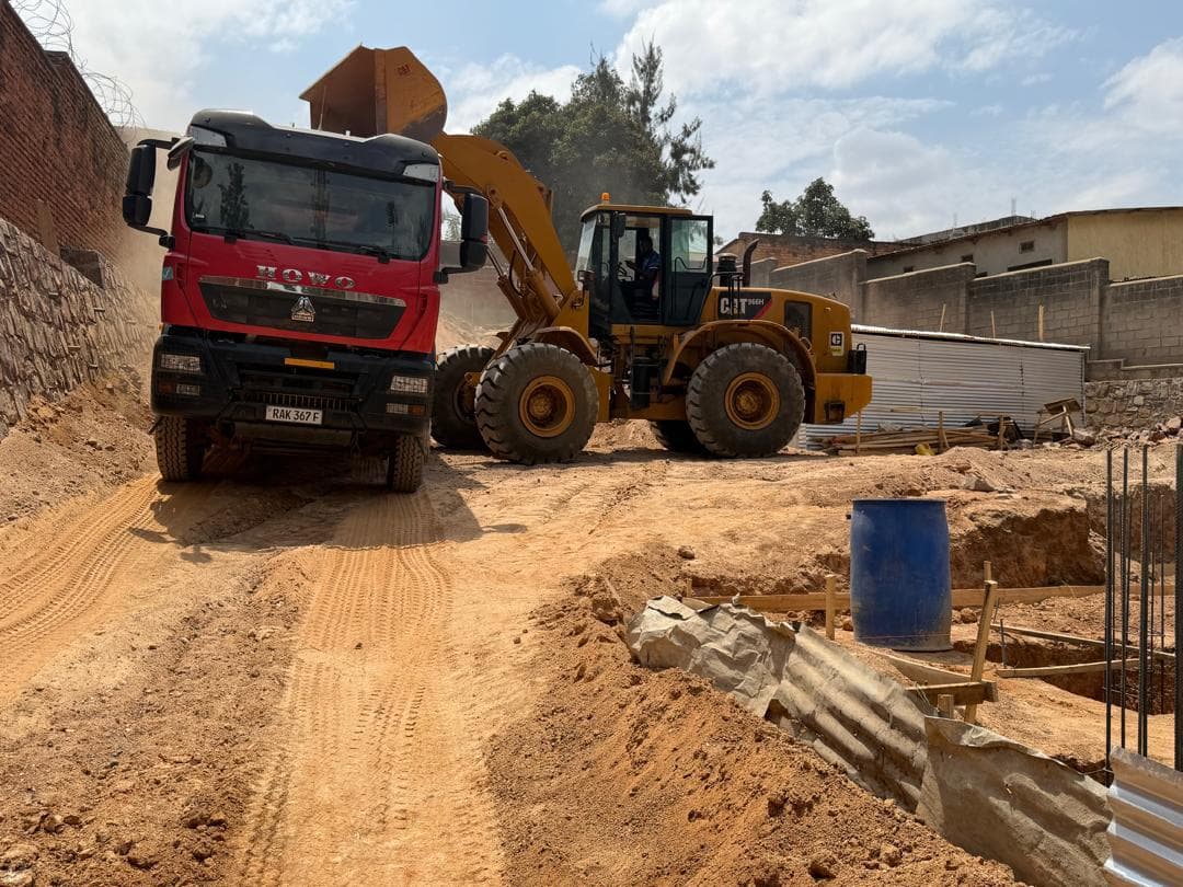 HOWO tipper truck and Caterpillar 966H loader on a Kigali construction site